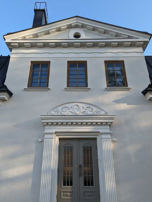 Man Sitting on a Chair Reading a Book